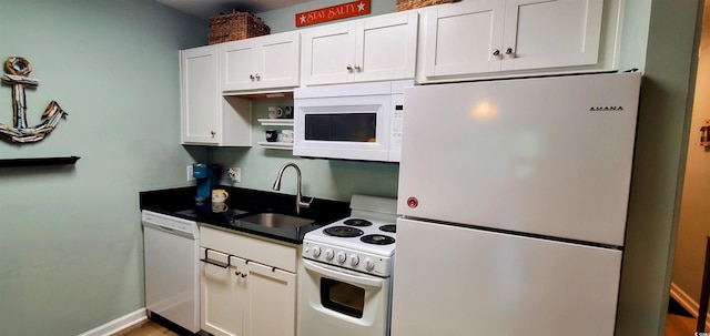 kitchen featuring white cabinets, dark countertops, open shelves, a sink, and white appliances