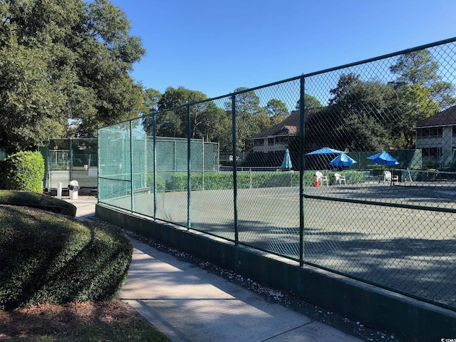 view of tennis court with fence