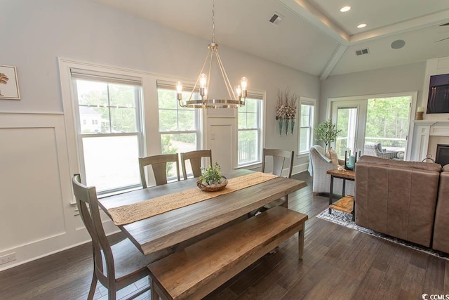 dining space with a healthy amount of sunlight, vaulted ceiling, and visible vents
