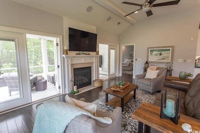 living room featuring visible vents, a fireplace with flush hearth, vaulted ceiling with beams, hardwood / wood-style flooring, and a ceiling fan