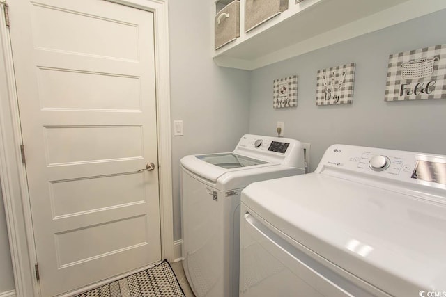 laundry room featuring laundry area, tile patterned flooring, and separate washer and dryer