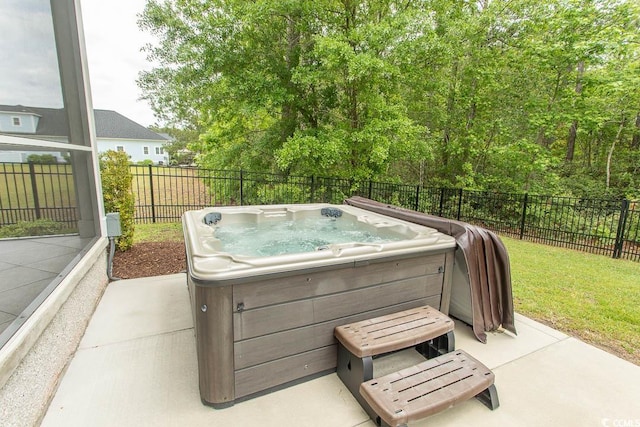 view of patio featuring a hot tub and fence