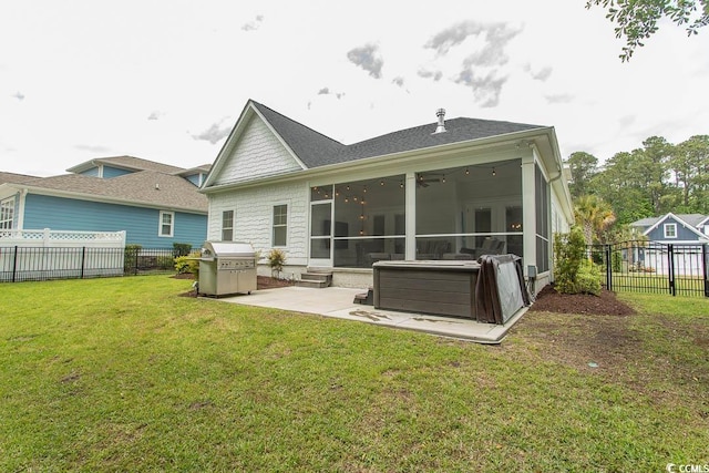 back of property with fence private yard, a patio area, a lawn, and a sunroom