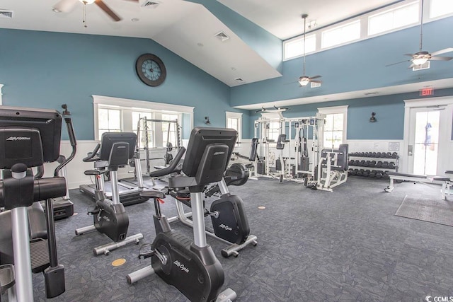 workout area with high vaulted ceiling, a ceiling fan, and visible vents