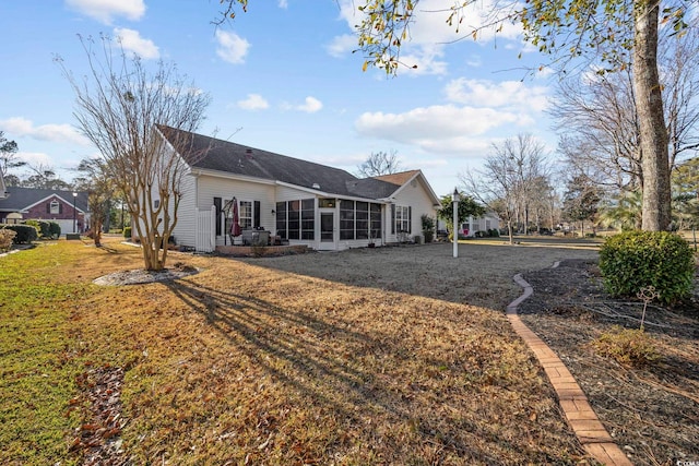 9628 Indigo Creek Blvd, Murrells Inlet, SC 29576 - back of property with a lawn, roof with shingles, and a sunroom