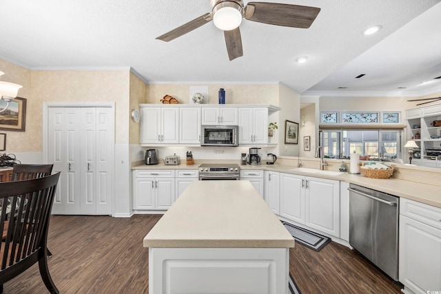 9628 Indigo Creek Blvd, Murrells Inlet, SC 29576 - kitchen featuring a ceiling fan, appliances with stainless steel finishes, a sink, dark wood-style floors, and ornamental molding