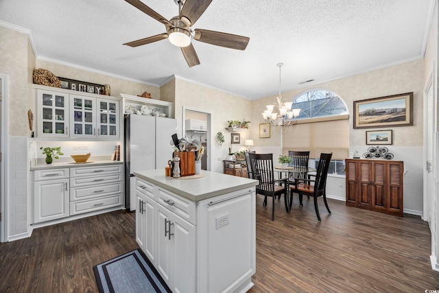 9628 Indigo Creek Blvd, Murrells Inlet, SC 29576 - kitchen with freestanding refrigerator, dark wood-style floors, light countertops, a textured ceiling, and white cabinets