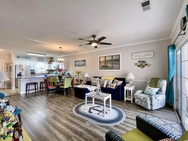 3979 Forsythia Ct Unit 203, Myrtle Beach, SC 29588 - living room featuring a textured ceiling, a ceiling fan, crown molding, and wood finished floors