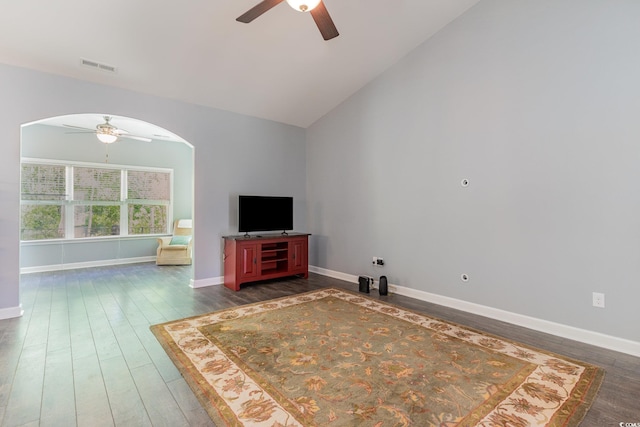 5581 Plantersville Pl, Myrtle Beach, SC 29579 - unfurnished living room with a ceiling fan, arched walkways, dark wood finished floors, baseboards, and vaulted ceiling