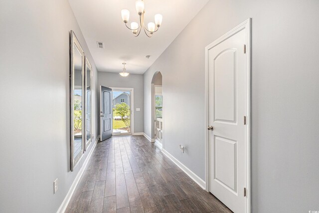 5581 Plantersville Pl, Myrtle Beach, SC 29579 - foyer entrance with arched walkways, dark wood-style floors, and a chandelier