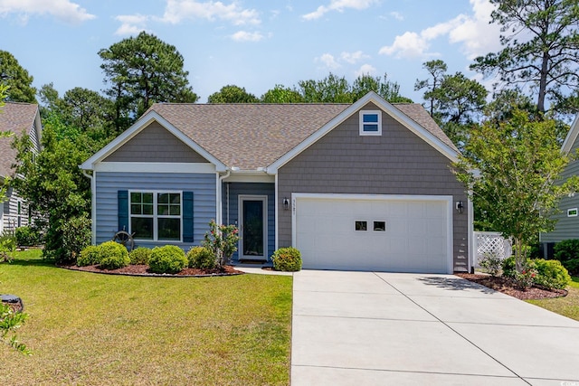 view of front of property with concrete driveway, an attached garage, a front yard, and a shingled roof