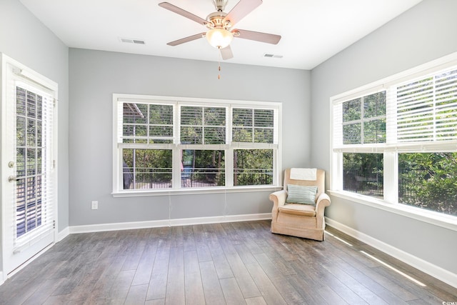unfurnished room with wood-type flooring, baseboards, and a ceiling fan