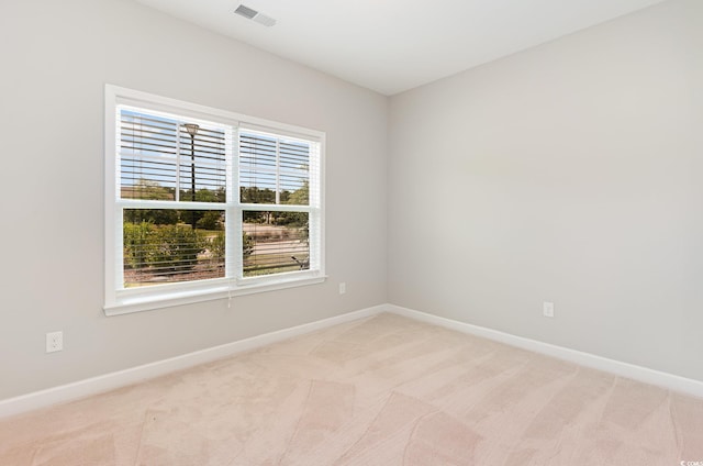 empty room with baseboards and light carpet