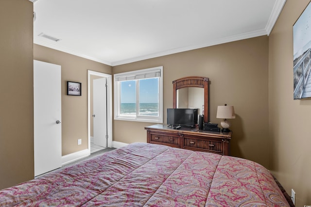 carpeted bedroom featuring crown molding, baseboards, and visible vents