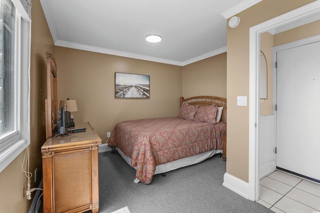 bedroom with baseboards, light colored carpet, and ornamental molding