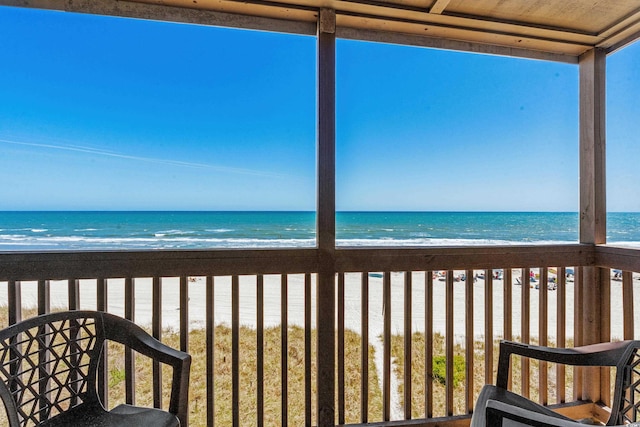 exterior space featuring a water view and a beach view