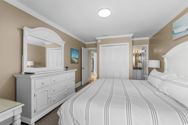 carpeted bedroom with visible vents, crown molding, baseboards, a closet, and ensuite bath