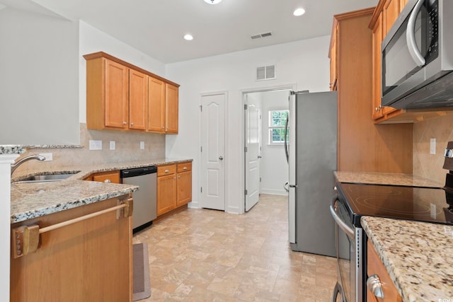 853 Derbyshire Ct, Conway, SC 29526 - kitchen featuring appliances with stainless steel finishes, a sink, light stone countertops, decorative backsplash, and recessed lighting