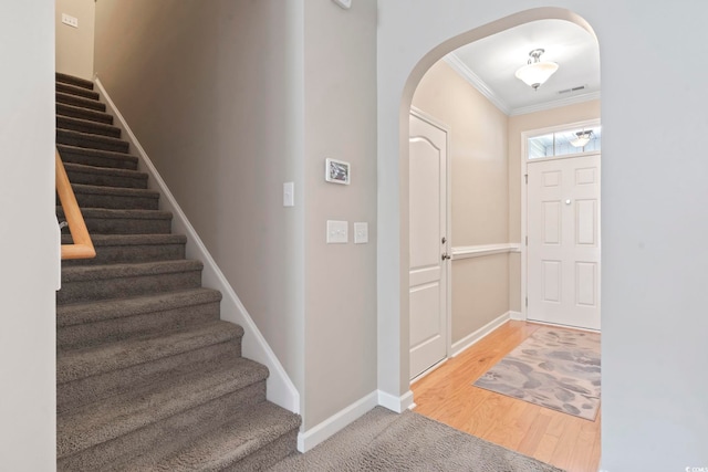 853 Derbyshire Ct, Conway, SC 29526 - foyer entrance with arched walkways, crown molding, stairs, baseboards, and wood finished floors
