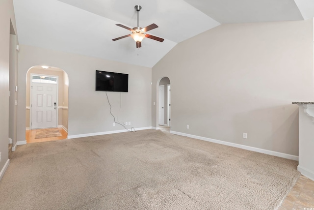 853 Derbyshire Ct, Conway, SC 29526 - unfurnished living room with arched walkways, ceiling fan, lofted ceiling, baseboards, and light carpet