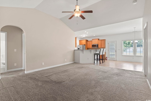 853 Derbyshire Ct, Conway, SC 29526 - living area featuring vaulted ceiling, light carpet, arched walkways, ceiling fan, and baseboards