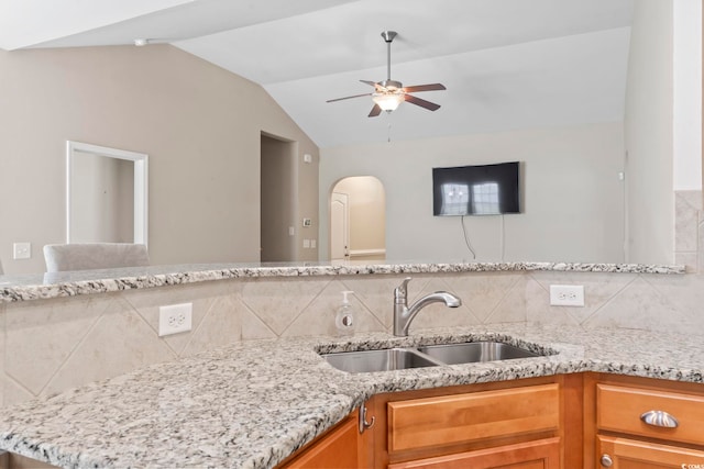 853 Derbyshire Ct, Conway, SC 29526 - kitchen with a sink, tasteful backsplash, vaulted ceiling, arched walkways, and light stone counters