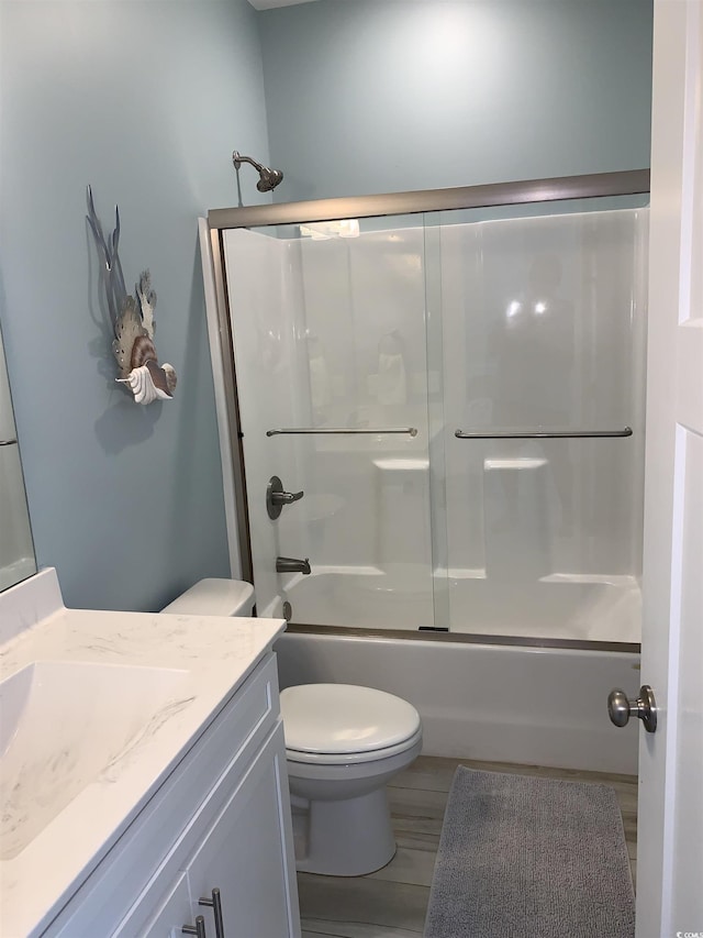 928STRANDAVE Strand Ave, North Myrtle Beach, SC 29582 - bathroom featuring vanity, combined bath / shower with glass door, wood finished floors, and toilet