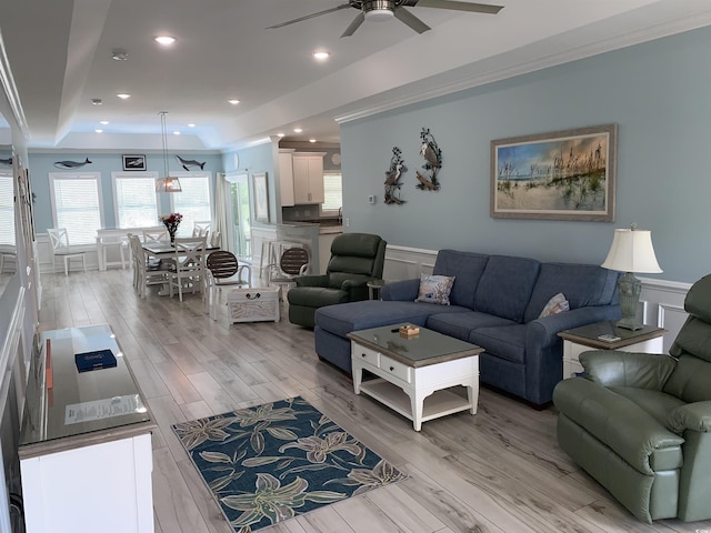 928STRANDAVE Strand Ave, North Myrtle Beach, SC 29582 - living room featuring a ceiling fan, crown molding, wainscoting, light wood-type flooring, and a tray ceiling