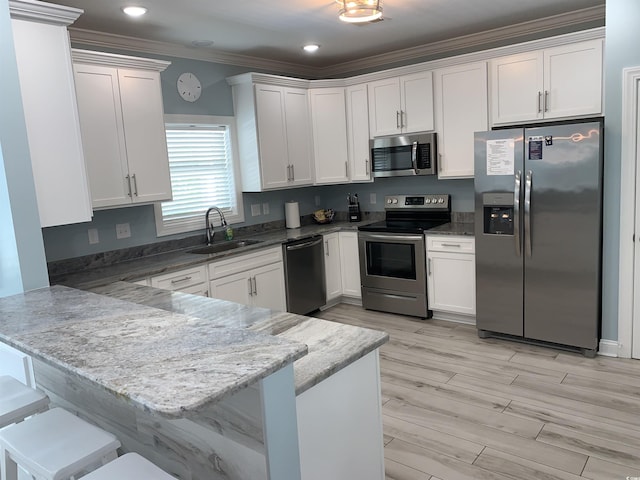 928STRANDAVE Strand Ave, North Myrtle Beach, SC 29582 - kitchen featuring crown molding, stainless steel appliances, white cabinetry, and a sink