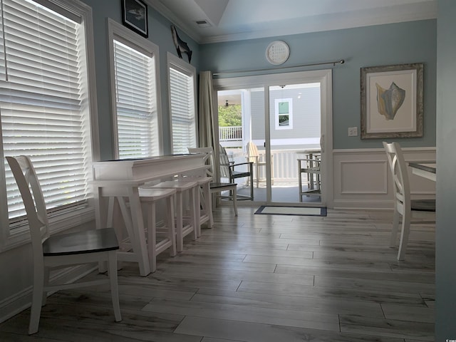 928STRANDAVE Strand Ave, North Myrtle Beach, SC 29582 - dining space with visible vents, wainscoting, wood finished floors, and lofted ceiling