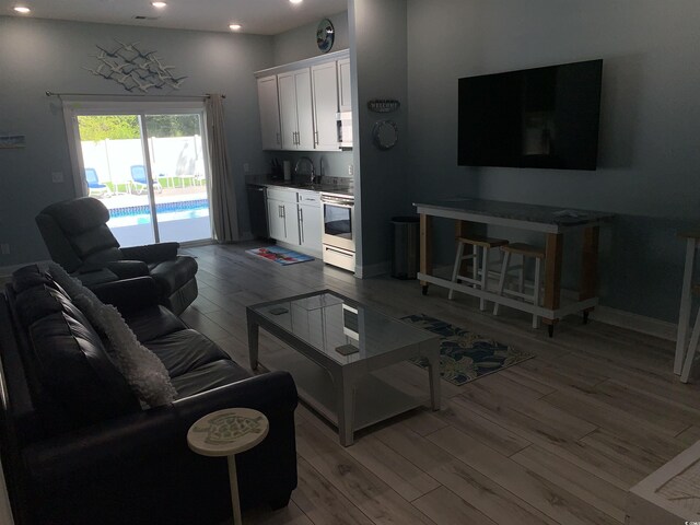 928STRANDAVE Strand Ave, North Myrtle Beach, SC 29582 - living room featuring recessed lighting, baseboards, and light wood finished floors