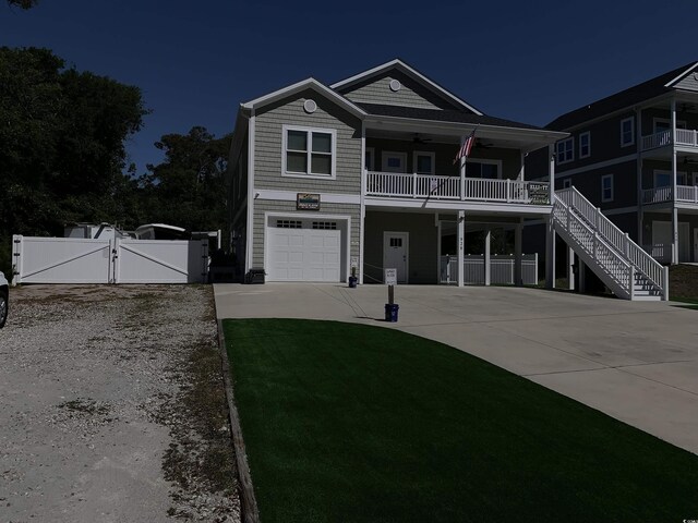 928STRANDAVE Strand Ave, North Myrtle Beach, SC 29582 - raised beach house featuring fence, stairs, a gate, concrete driveway, and an attached garage