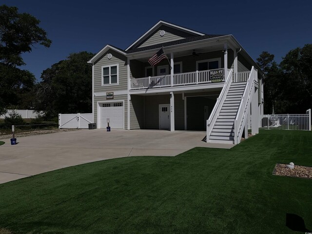928STRANDAVE Strand Ave, North Myrtle Beach, SC 29582 - view of front facade featuring fence, a front lawn, concrete driveway, an attached garage, and stairs