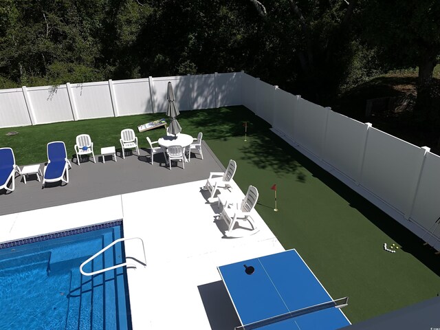 928STRANDAVE Strand Ave, North Myrtle Beach, SC 29582 - view of pool featuring a fenced backyard, a fenced in pool, a lawn, and a patio