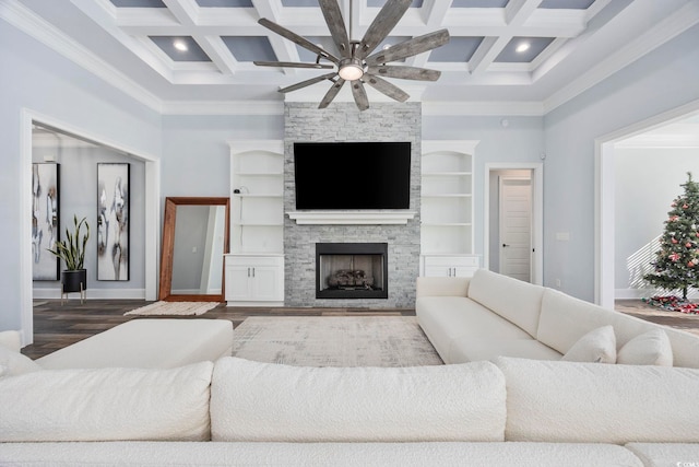 living area with ornamental molding, coffered ceiling, and ceiling fan