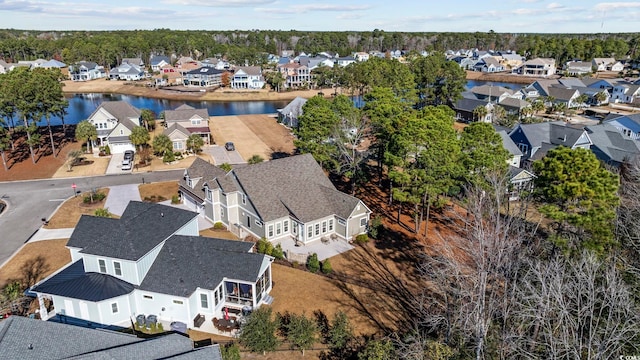 birds eye view of property with a water view and a residential view