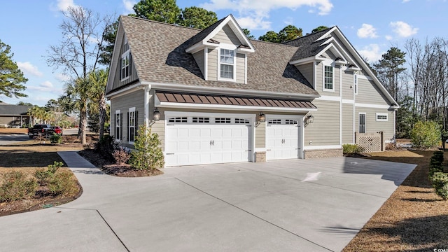 view of property exterior featuring concrete driveway and roof with shingles