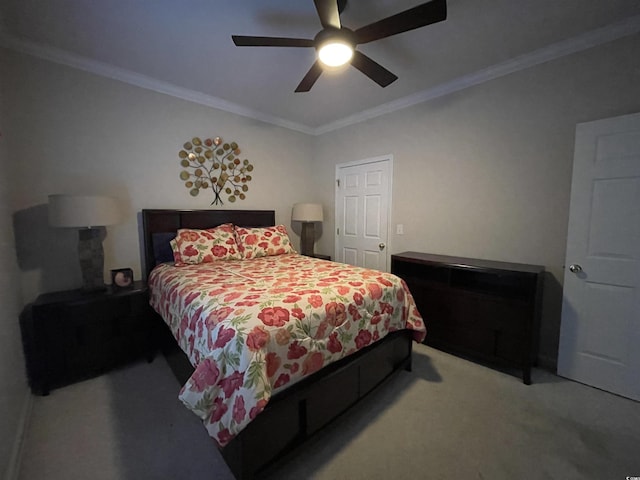 carpeted bedroom with ornamental molding and a ceiling fan