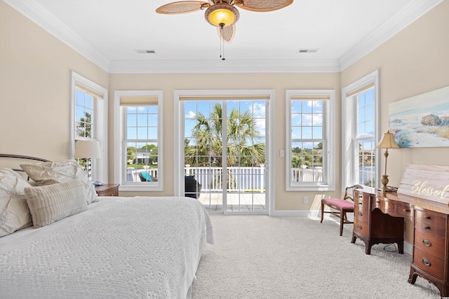 carpeted bedroom with visible vents, baseboards, crown molding, and access to exterior