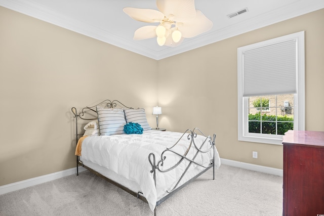 bedroom featuring crown molding, ceiling fan, carpet, baseboards, and visible vents