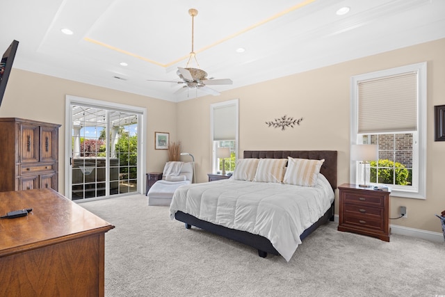 bedroom with access to outside, light colored carpet, a raised ceiling, a ceiling fan, and recessed lighting
