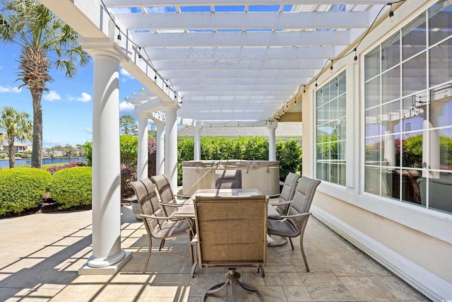 view of patio with outdoor dining area, a water view, a hot tub, and a pergola
