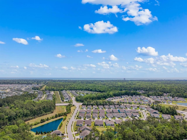 birds eye view of property with a residential view, a water view, and a wooded view