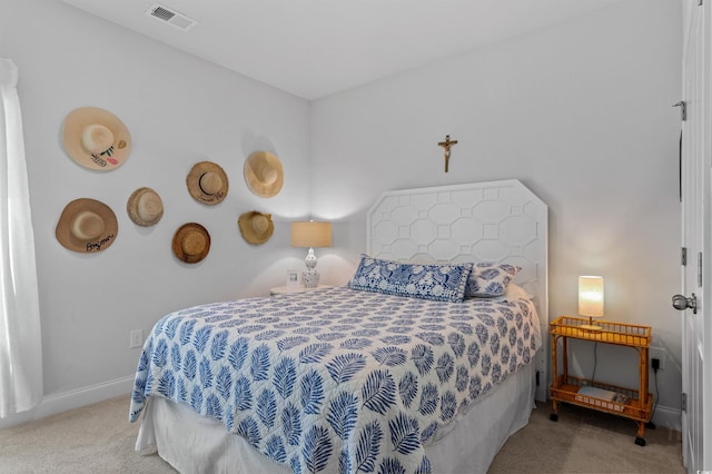 carpeted bedroom featuring baseboards and visible vents