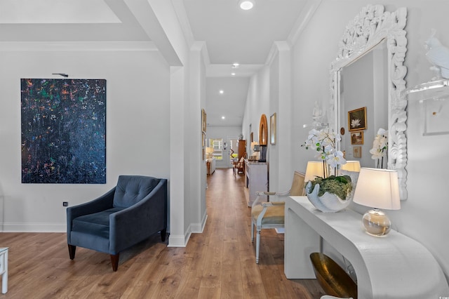 hallway with crown molding, baseboards, recessed lighting, and wood finished floors