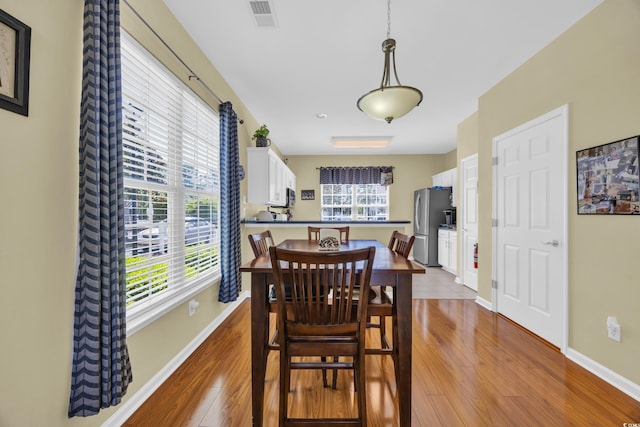 260 Connemara Dr Unit E, Myrtle Beach, SC 29579 - dining space featuring baseboards, wood finished floors, and visible vents