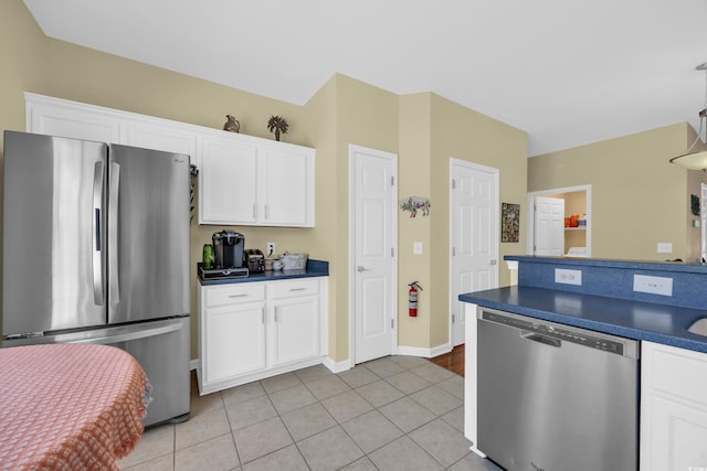 260 Connemara Dr Unit E, Myrtle Beach, SC 29579 - kitchen featuring white cabinets, dark countertops, appliances with stainless steel finishes, and light tile patterned floors