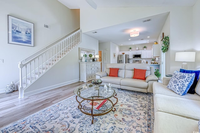 104-4 Gully Branch Ln Unit 4, Myrtle Beach, SC 29572 - living area with stairway, light wood-type flooring, baseboards, and high vaulted ceiling
