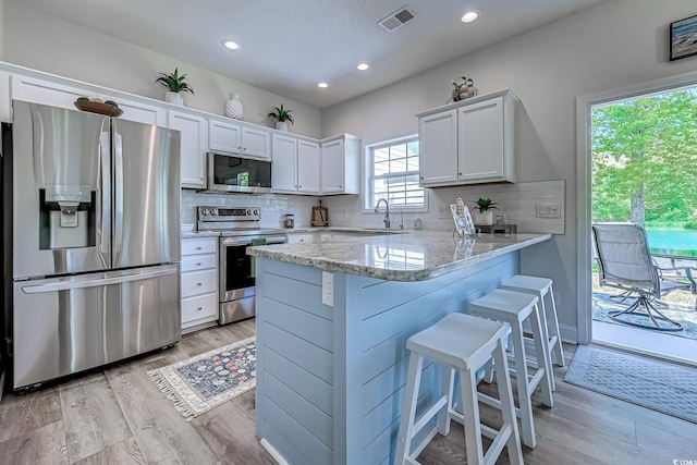 104-4 Gully Branch Ln Unit 4, Myrtle Beach, SC 29572 - kitchen with stainless steel appliances, a sink, white cabinetry, backsplash, and recessed lighting