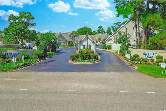 104-4 Gully Branch Ln Unit 4, Myrtle Beach, SC 29572 - view of asphalt road featuring a residential view, a gated entry, traffic signs, and curbs
